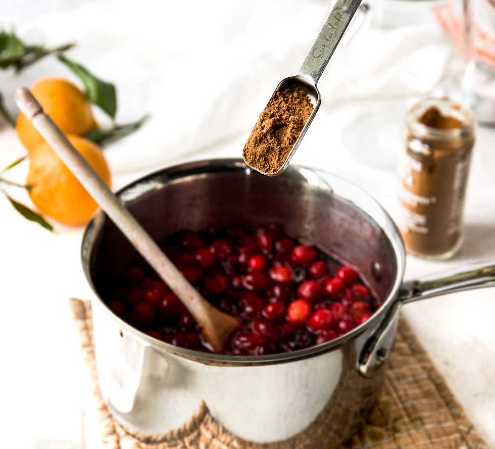 Adding five spice to cranberries.