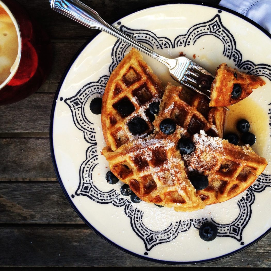 Delicious buttermilk waffles with blueberries and maple syrup