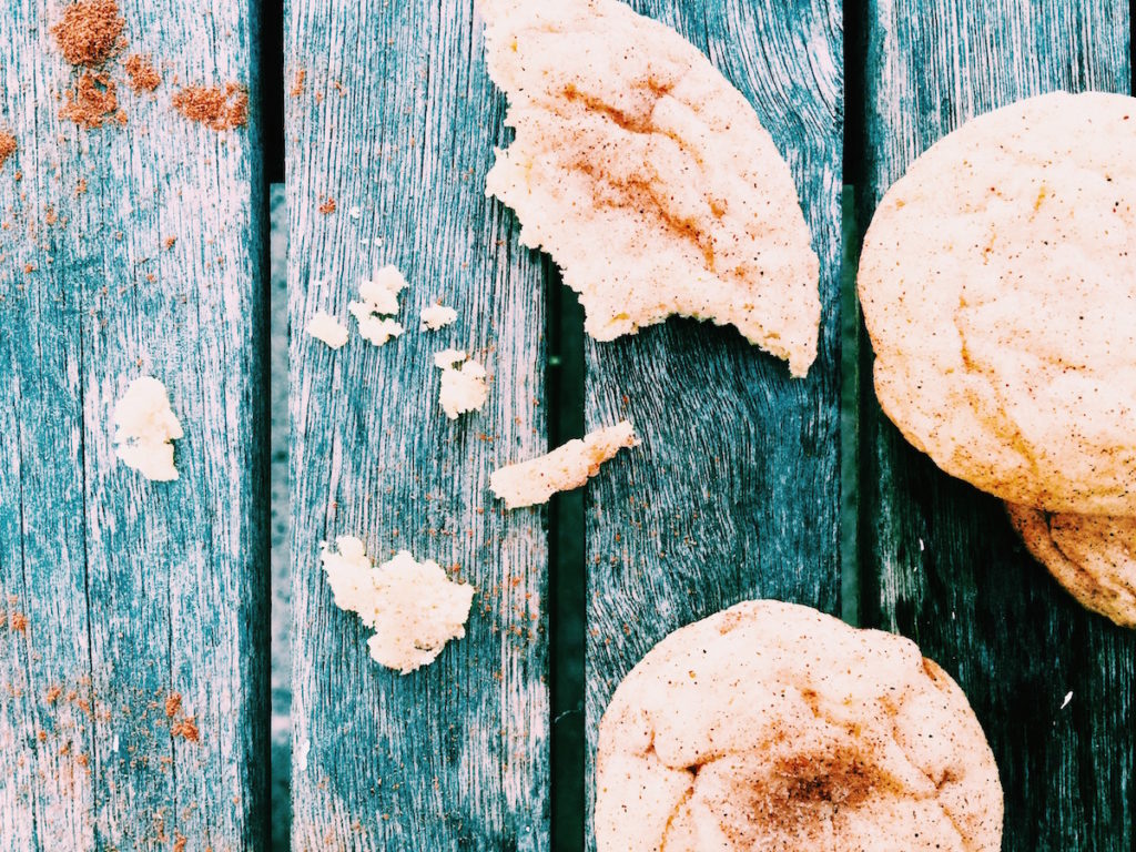 Snickerdoodle pieces on a wood surface.