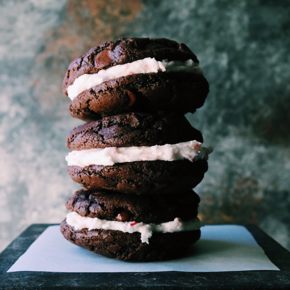 A stack of chewy brownie cookies sandwich a thick layer of peppermint cream!!