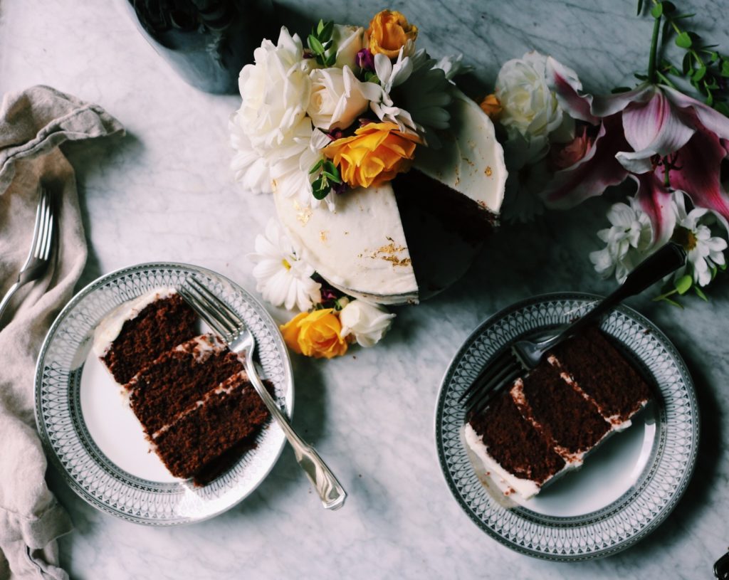 Gilded Dark Chocolate Cake With Champagne Buttermilk | Recipe via DisplacedHousewife | This all sounds fancy, and it's for a fancy occasion, but we break it down into easy steps...including some make ahead stuff. A rich, buttermilk-driven chocolate cake is coated in a balanced champagne buttercream. Gold leaf is placed about and flowers brighten up the whole mood. Yep. It's Awards Season. Time to bust our your spanx and sequins. And this cake. xo