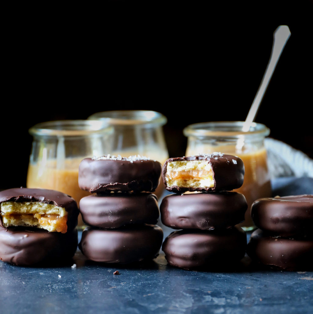 stacks of alfajores cookies dipped in chocolate and stuffed with dulce de leche
