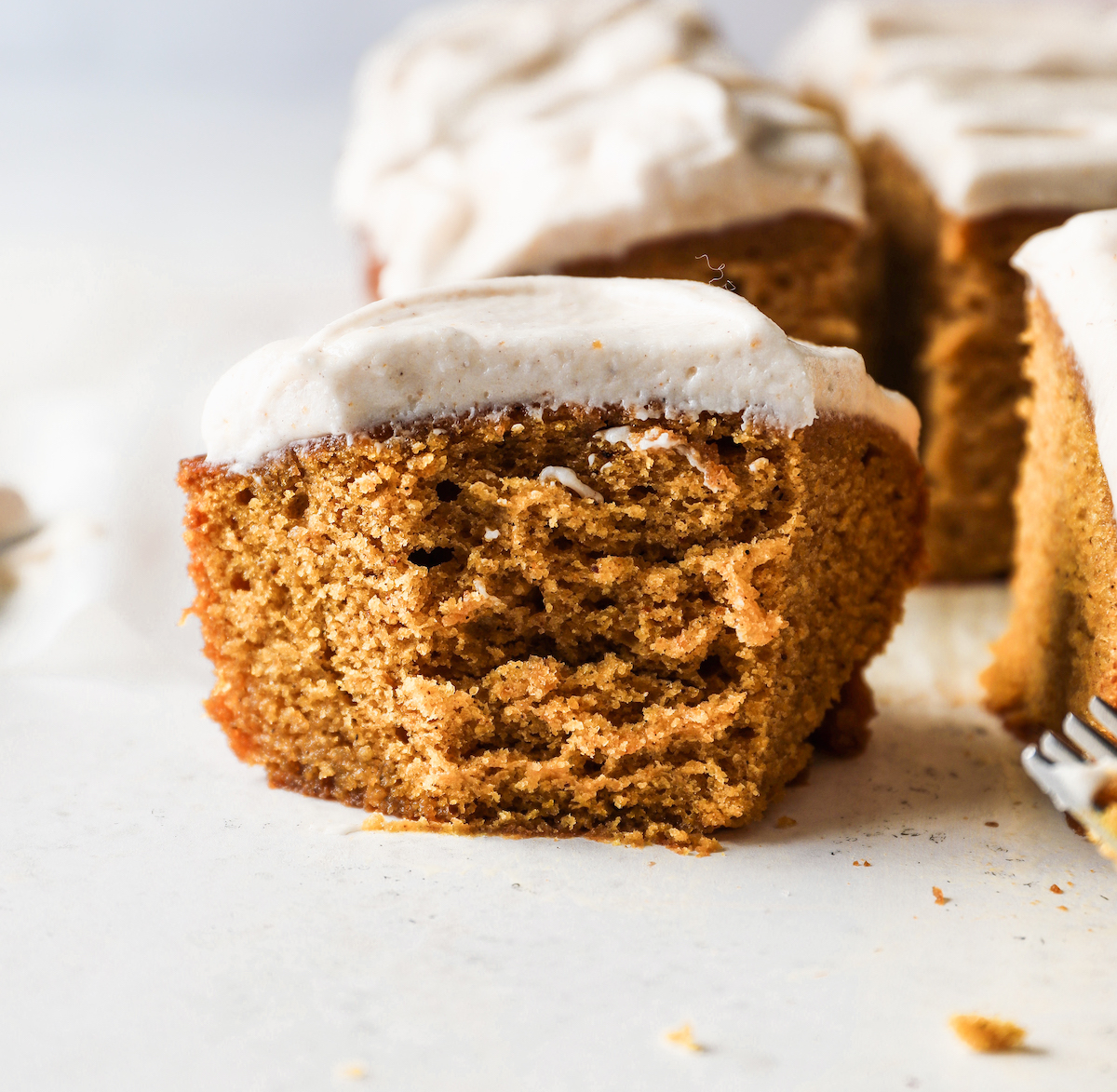 A slice of pumpkin bourbon cake with a bite out of it.