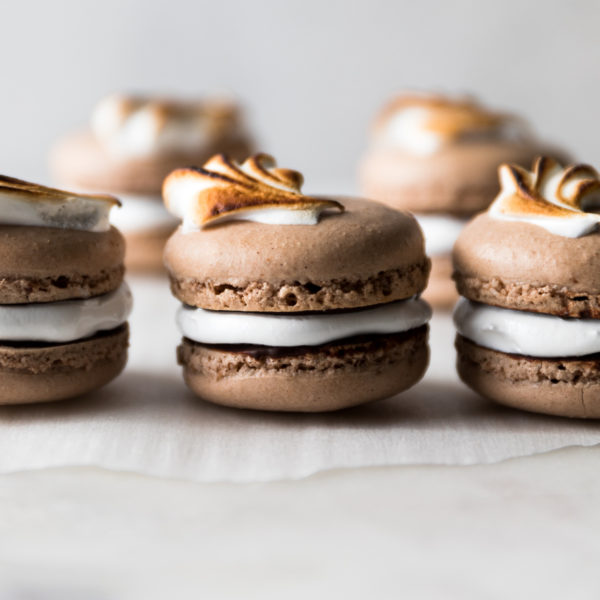 Classic chocolate French macarons are paired with a dreamy marshmallow filling. Each macaron is smeared in a mexican hot chocolate glaze for mega flavor!
