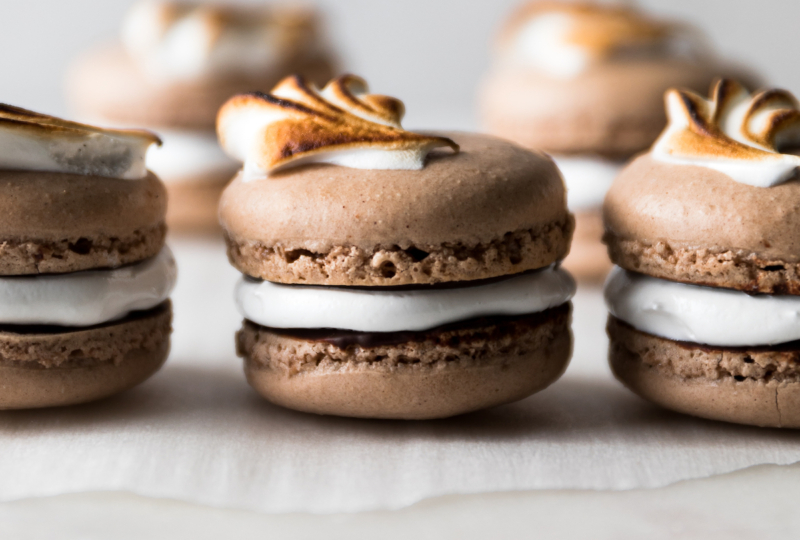 Classic chocolate French macarons are paired with a dreamy marshmallow filling. Each macaron is smeared in a mexican hot chocolate glaze for mega flavor!
