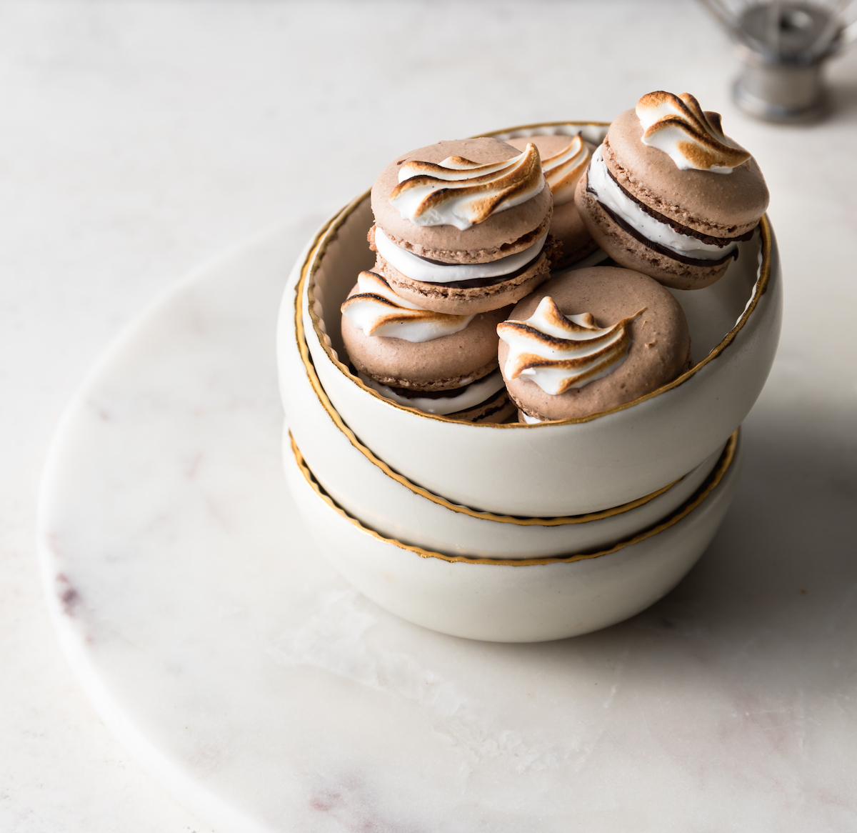 Chocolate French Macarons with marshmallow filling in a bowl