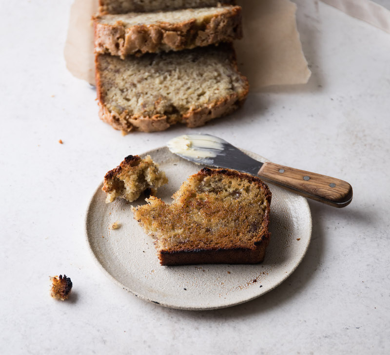 A slice of toasted banana bread with butter. So good.