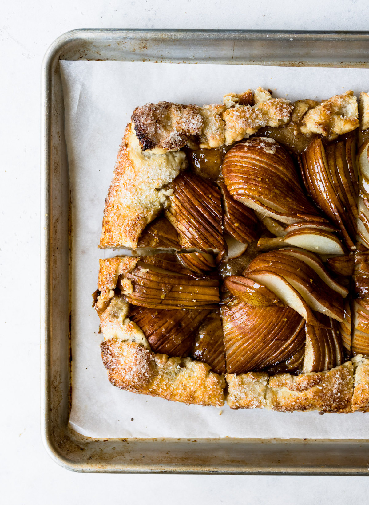 Salted Honey Pear Crostata on a parchment lined baking sheet.