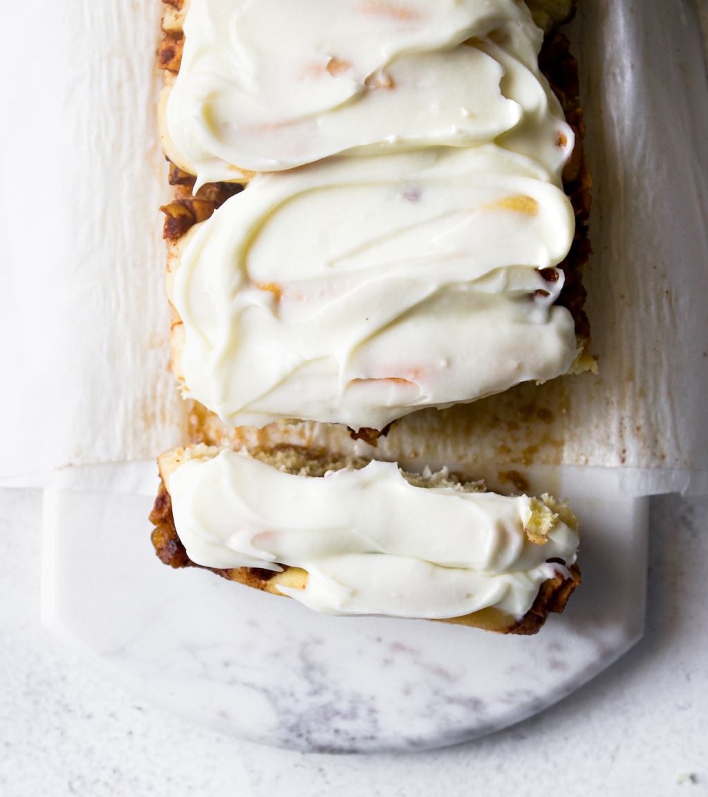 An overhead view of apple bread with cream cheese glaze.