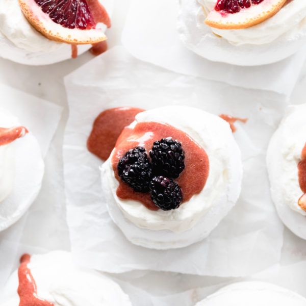 A bunch of meringues with blood orange curd