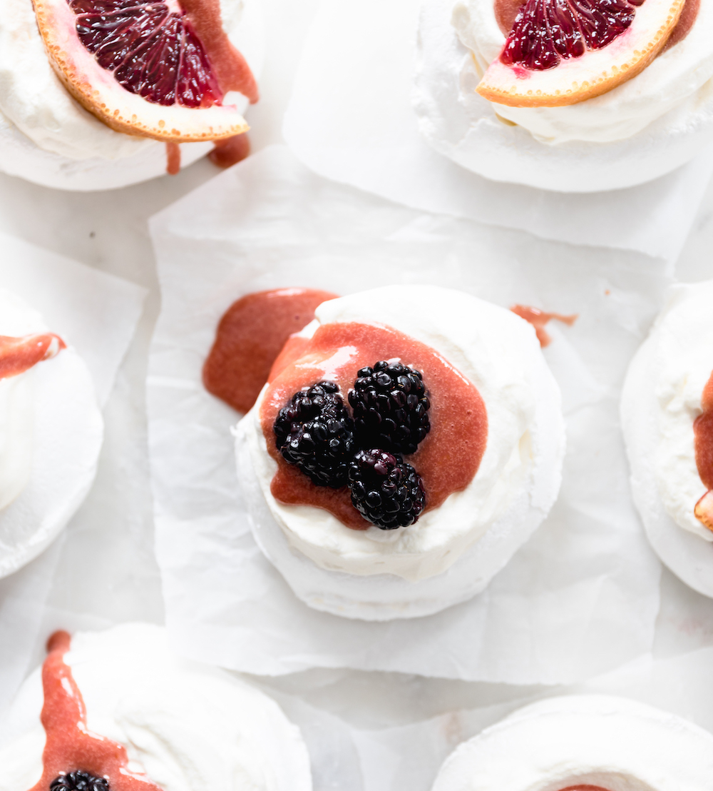 A bunch of meringues with blood orange curd