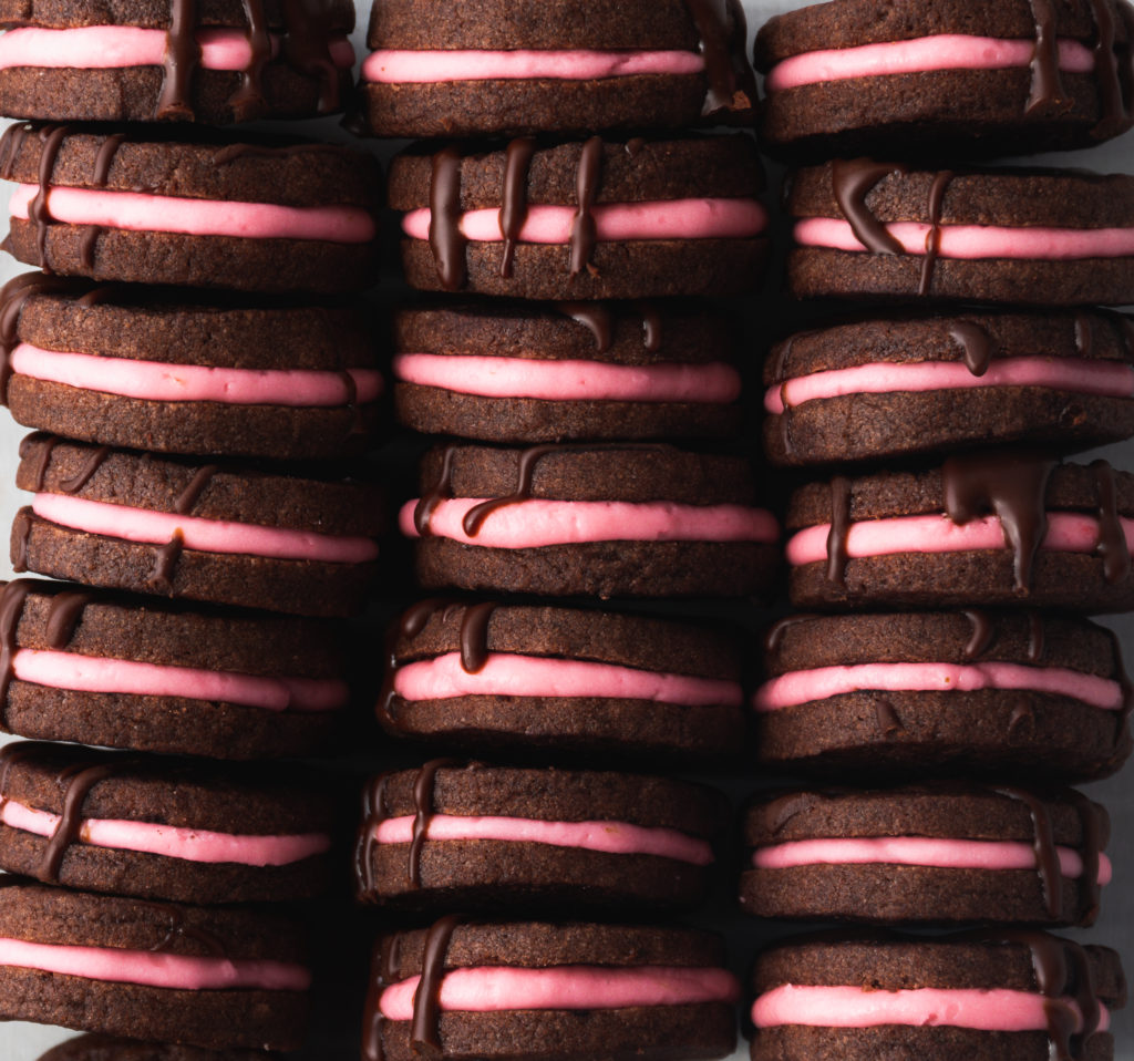 three rows of chocolate sandwich cookies stuffed with fresh strawberry  cream