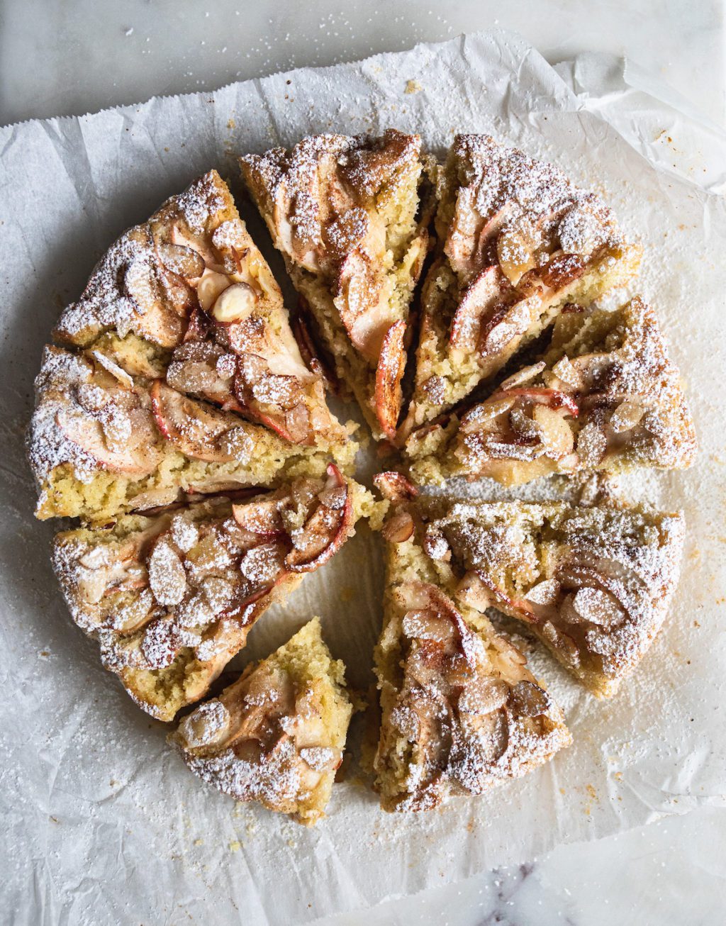 the whole apple cake, dusted in powdered sugar