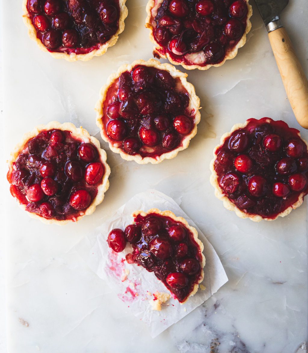cranberry tarts, one with a bite missing