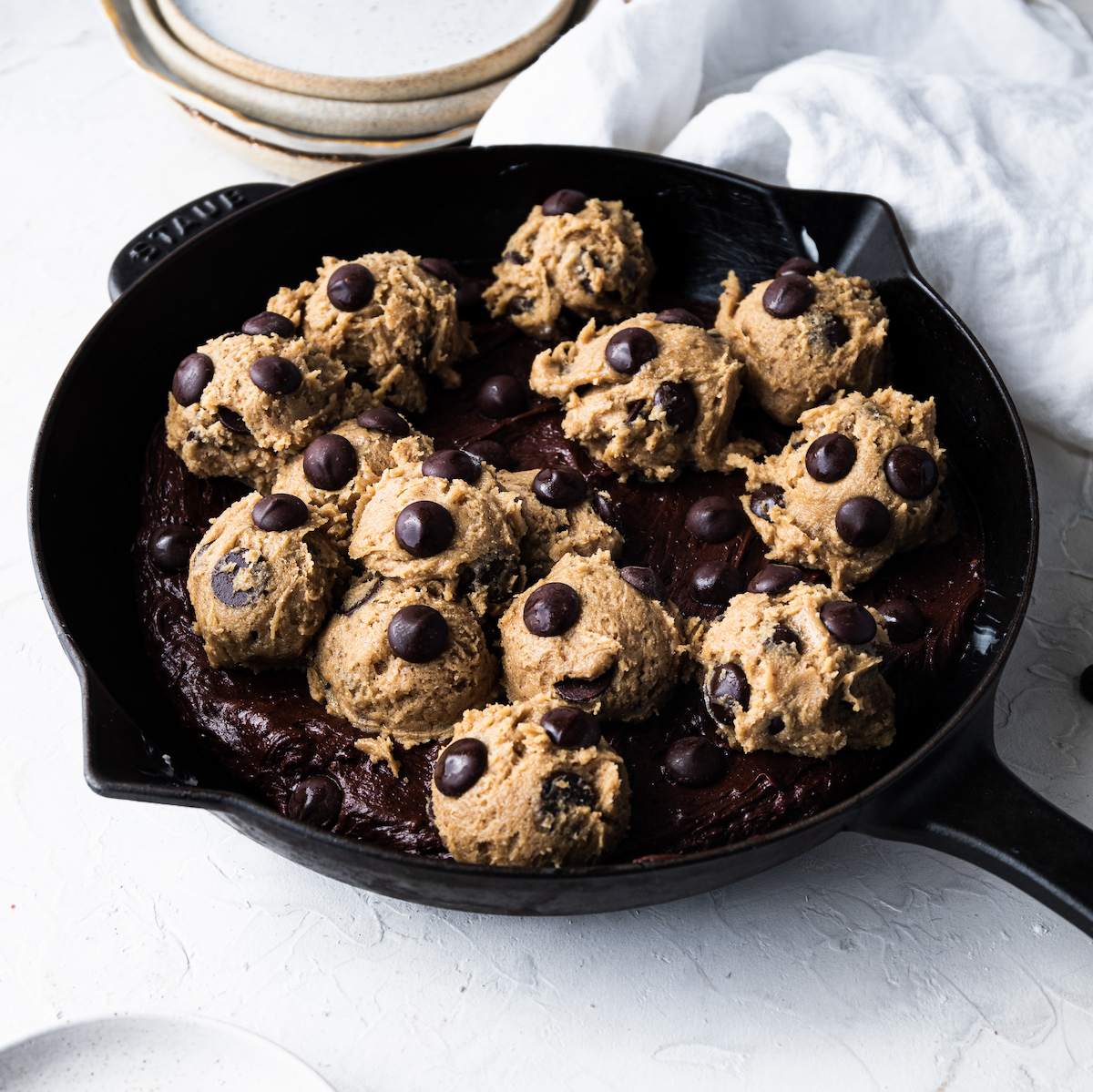 The unbaked ultimate skillet brookies with chocolate chips sprinkled on top