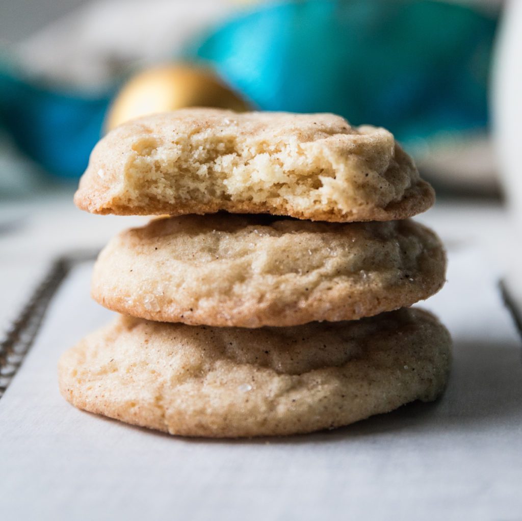 Stacked five spice snickerdoodles with a bite out of one of them