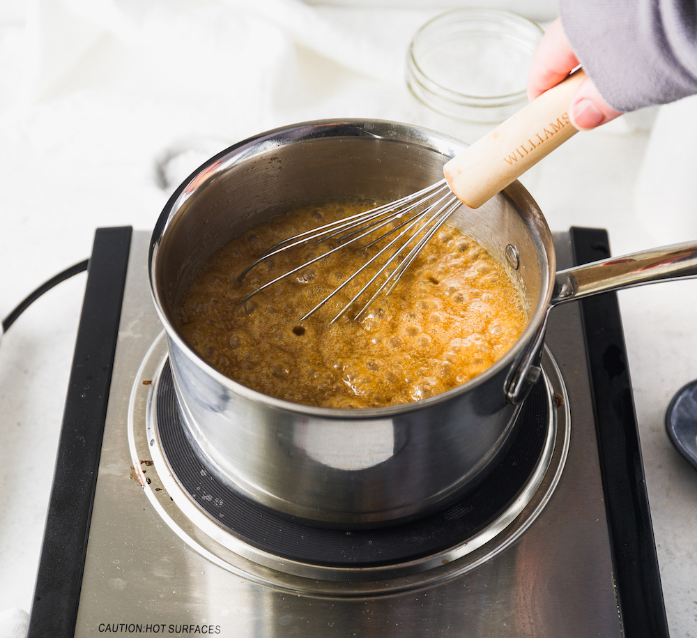Caramel boiling in a saucepan.