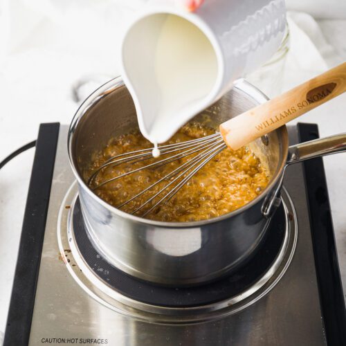 Pouring cream into a pan.