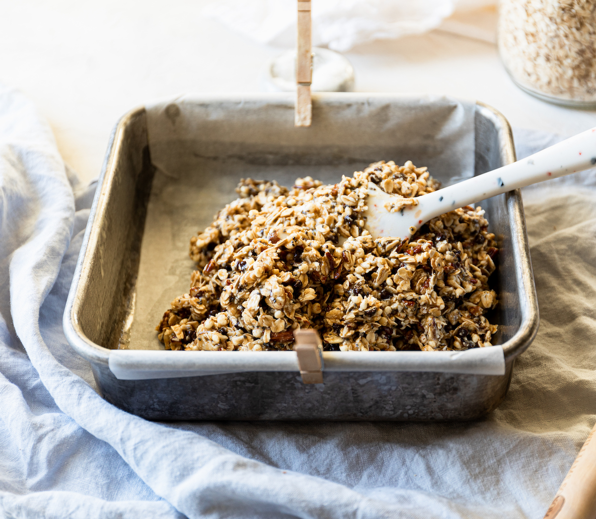 A baking dish with unbaked granola in it.
