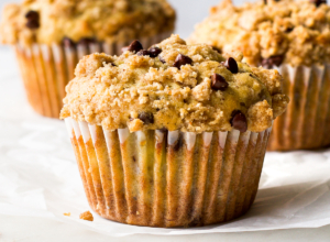 A close up of a banana chocolate chip muffin.