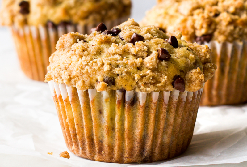 A close up of a banana chocolate chip muffin.
