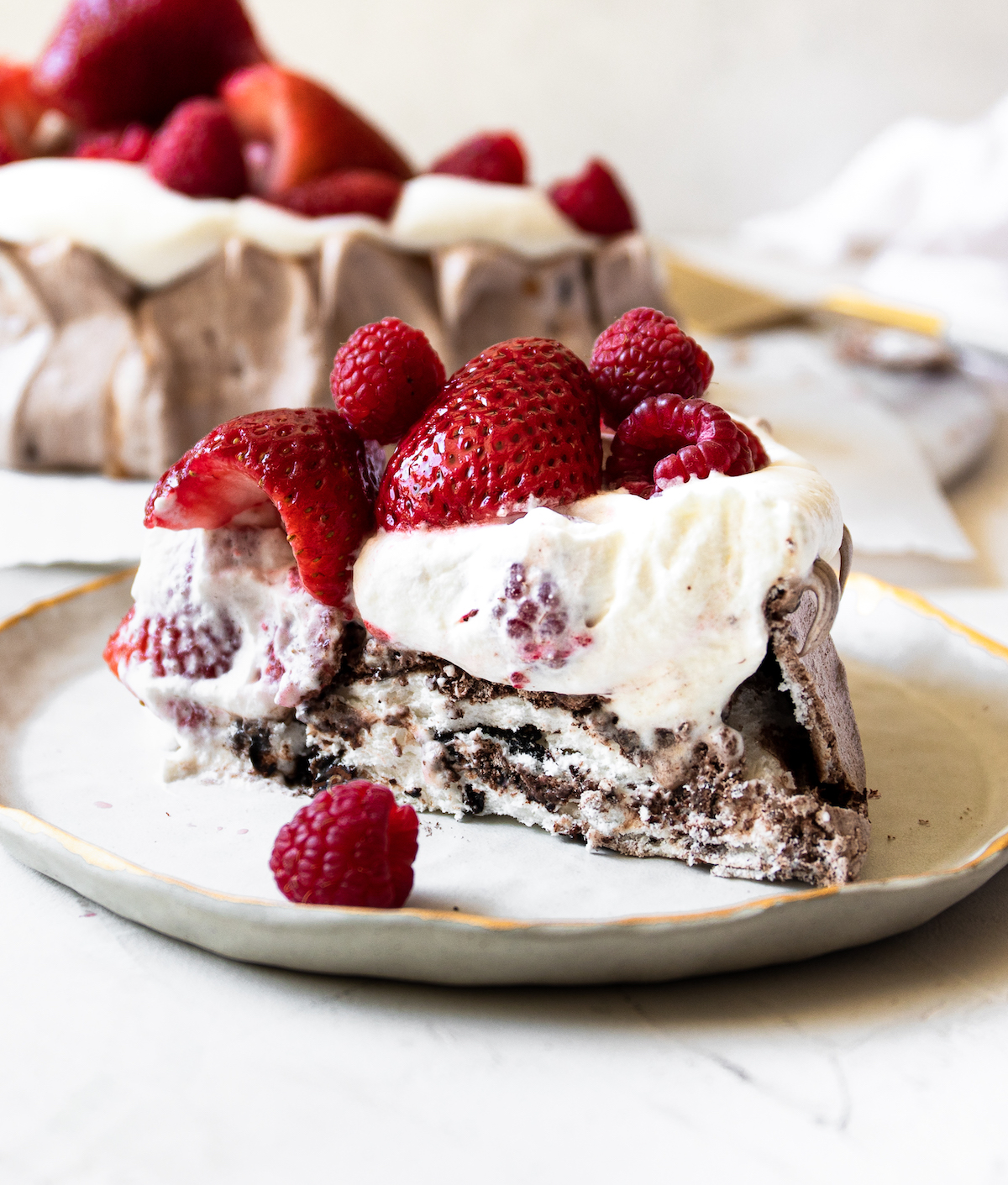 Chocolate pavlova with berries and whipped cream.