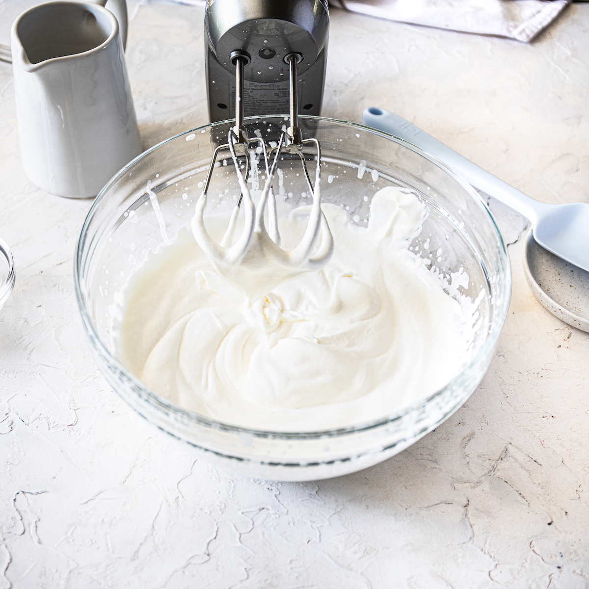 Perfect whipped cream in a glass bowl.