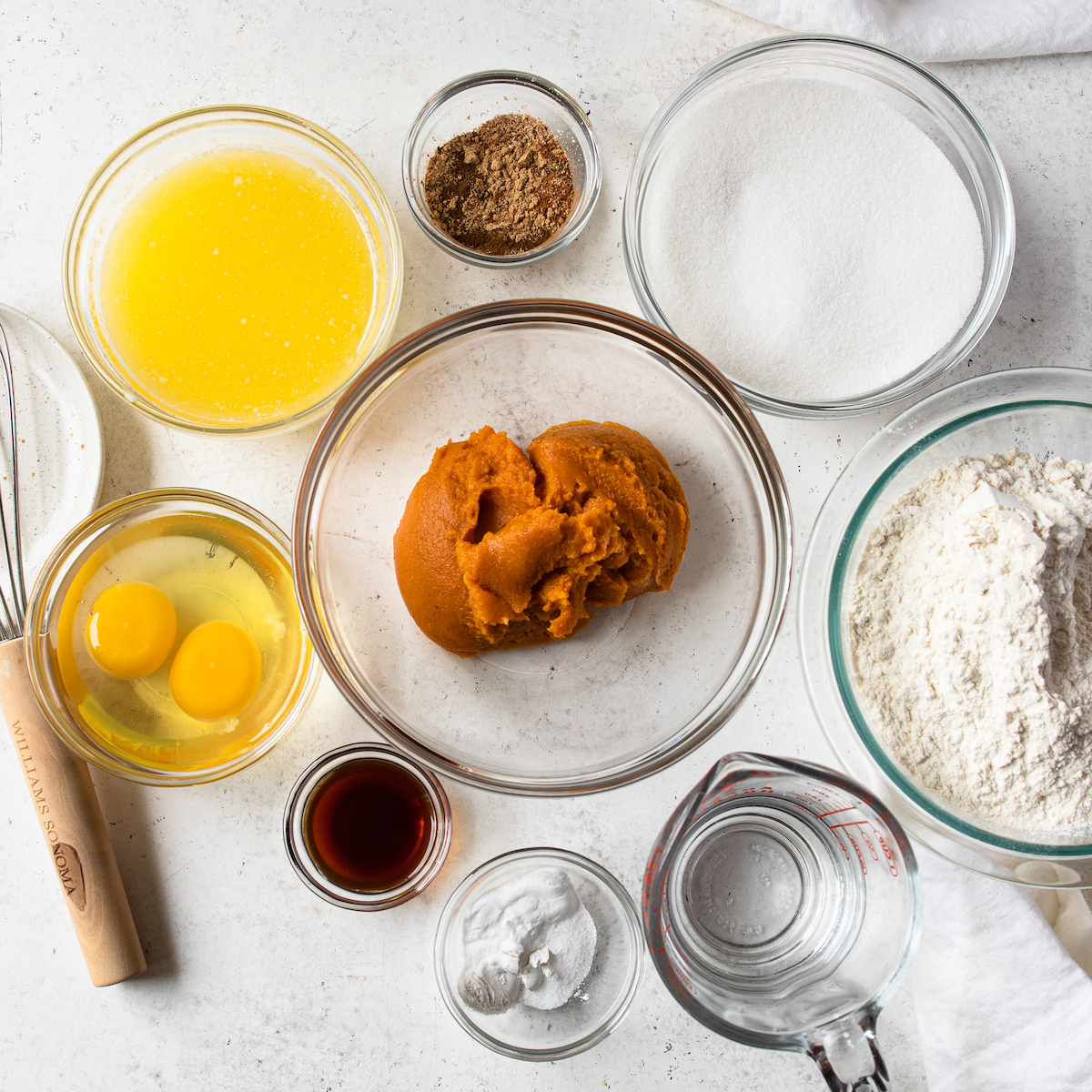 All of the ingredients to make a spiced pumpkin loaf.