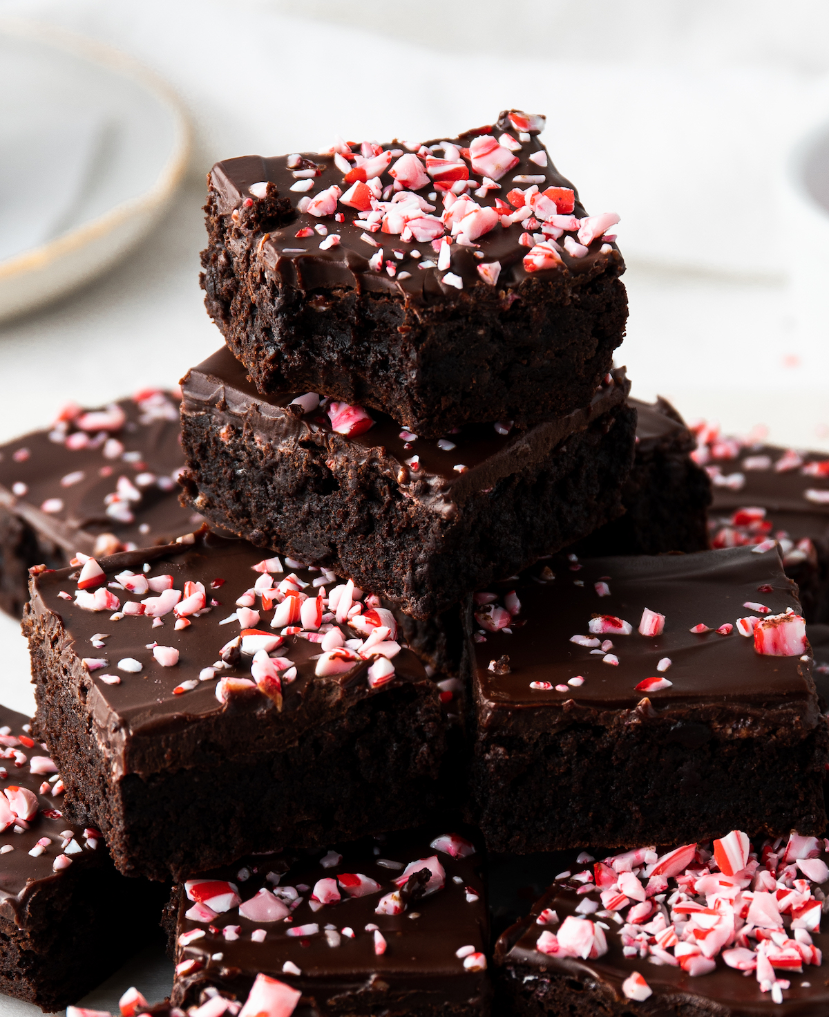 A stack of candy cane brownies and the top one has a bite out of it.