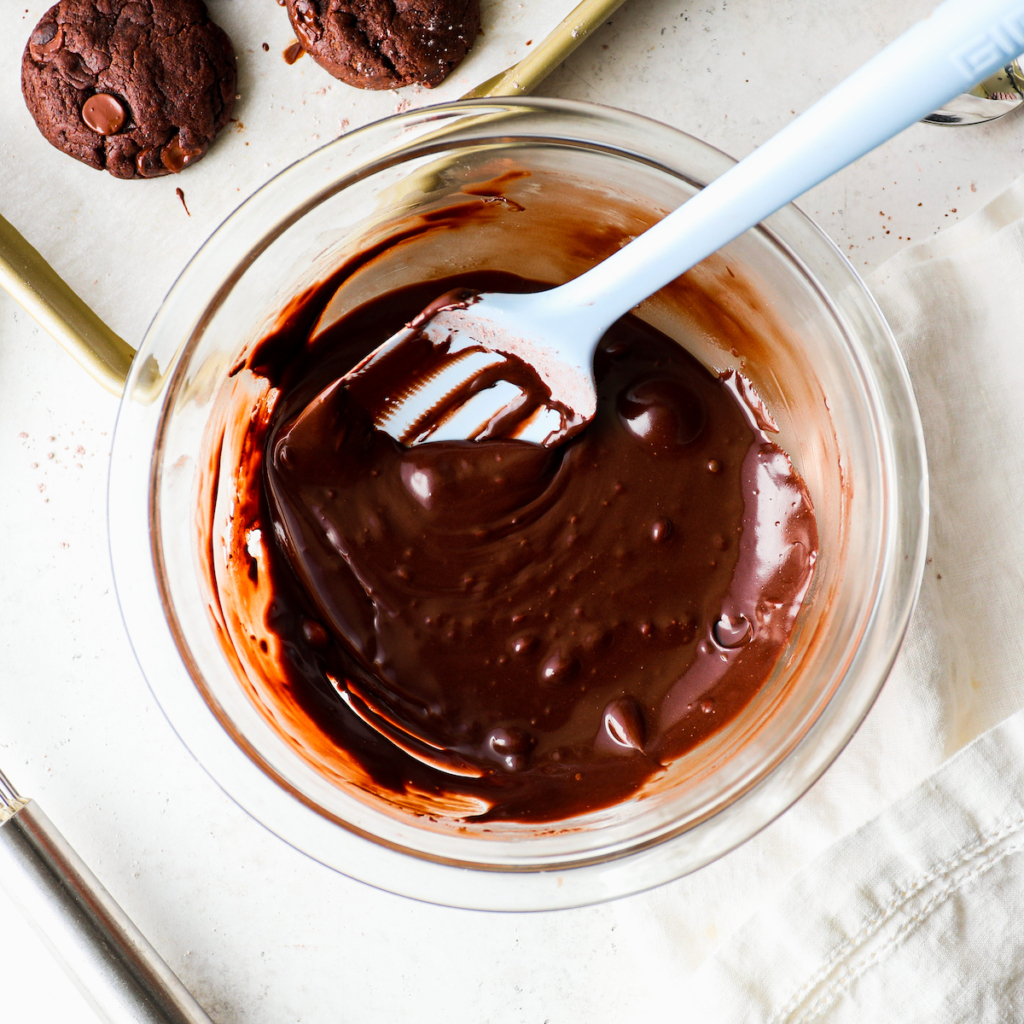 A glass bowl with vegan chocolate frosting.