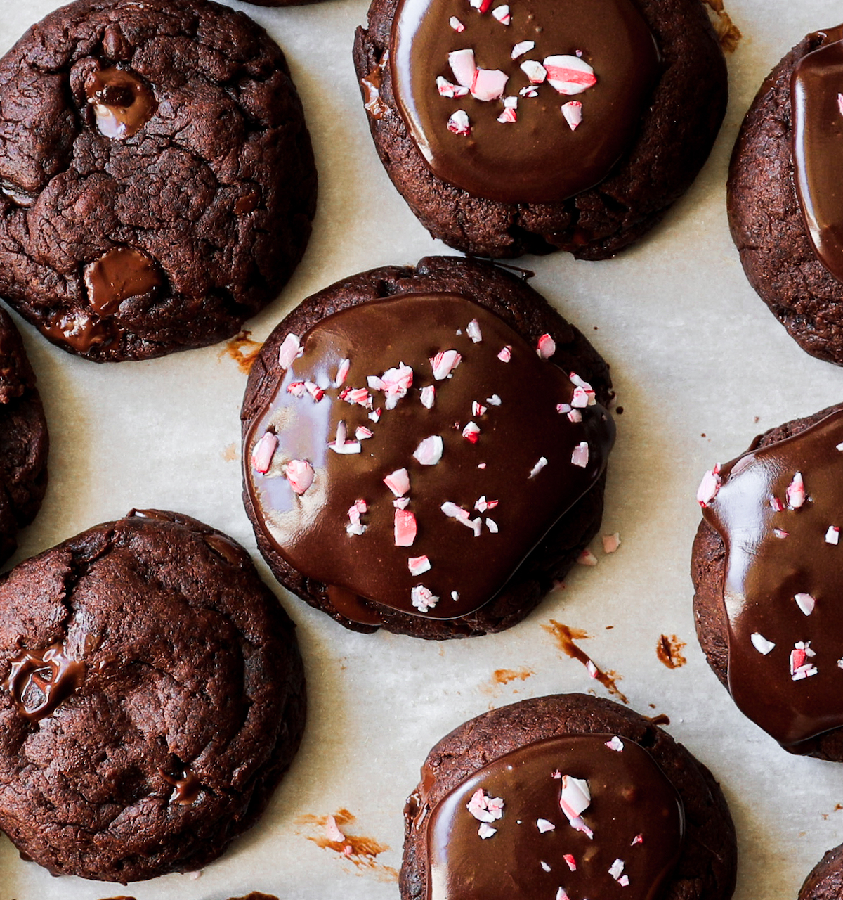 A bunch of vegan peppermint brownie cookies on parchment paper. 
