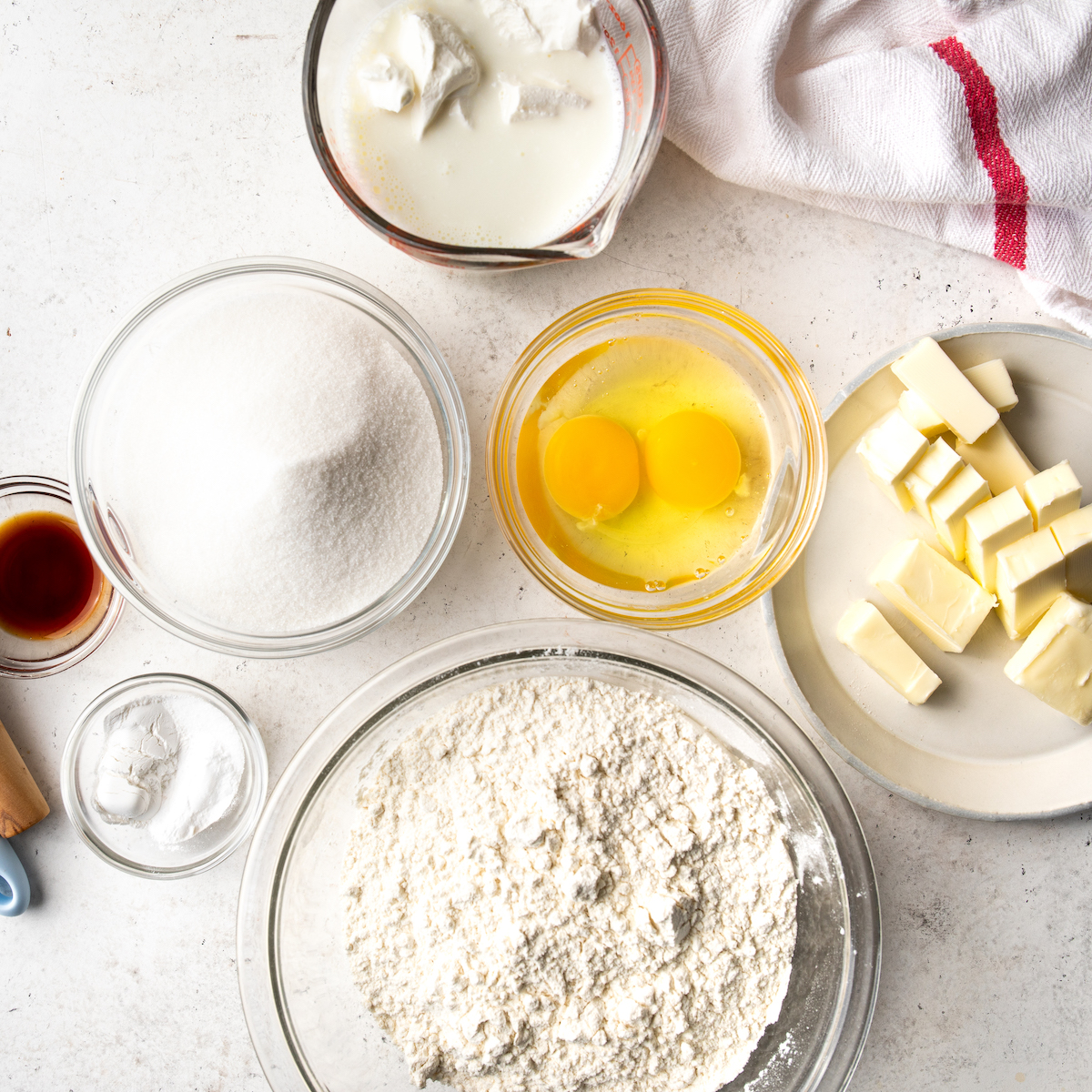 All of the ingredients to make coffee cake on a white surface.