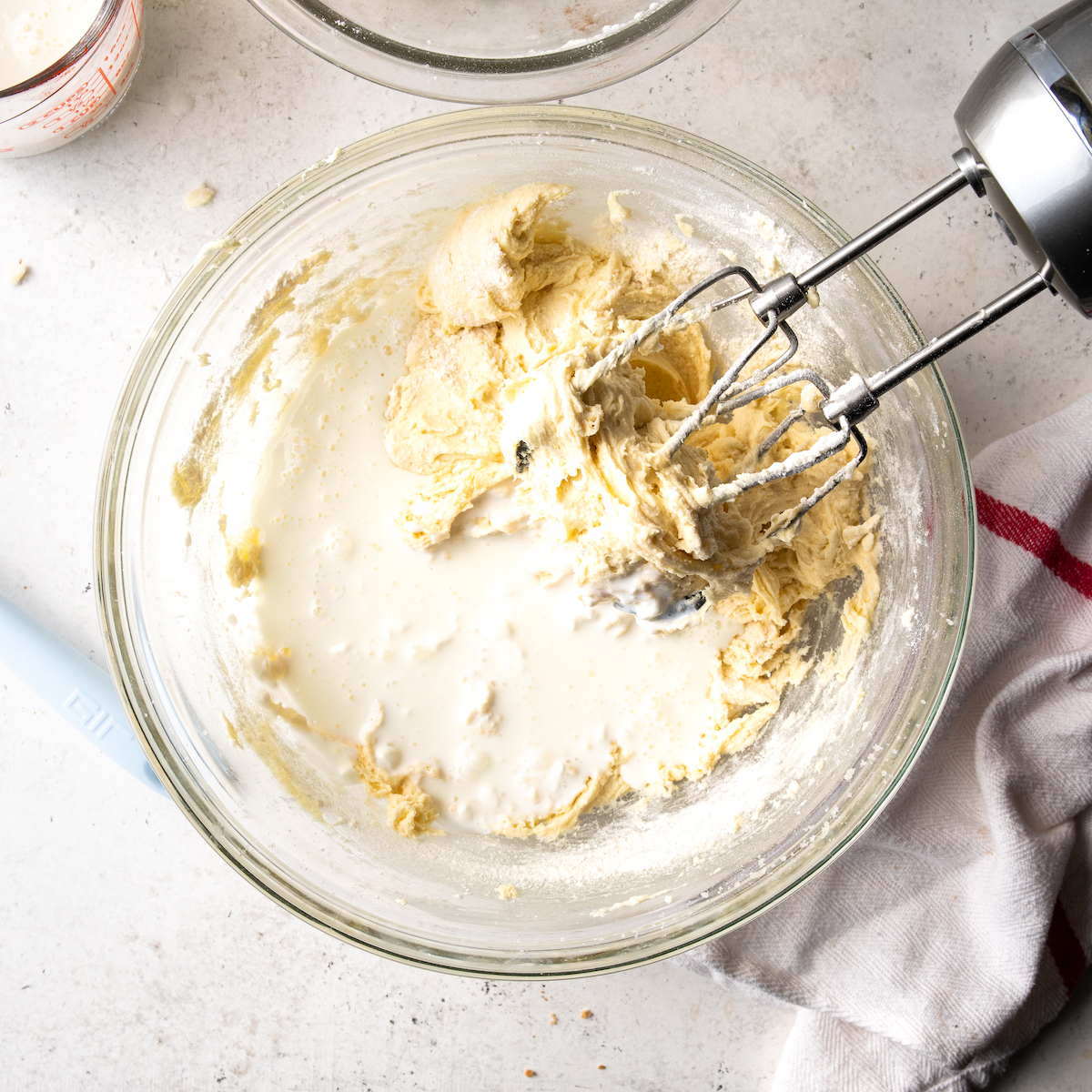 Adding the milk sour cream mixture to the cake batter.