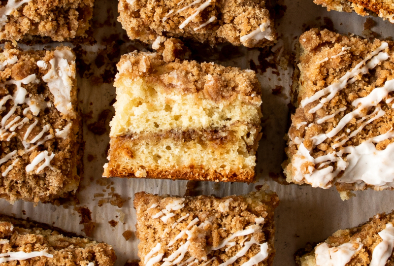 A piece of coffee cake on it's side, surrounded by more pieces of coffee cake.