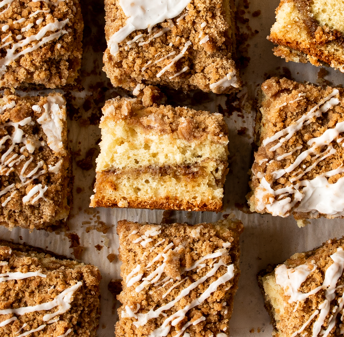 A side view of coffee cake showing a thick, crunchy layer of streusel. 
