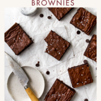 A bunch of brownies on crinkled parchment paper.