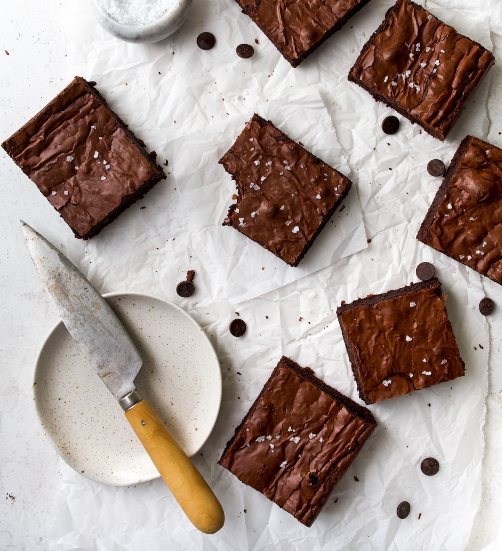 Cut pieces of brownies on a white surface.