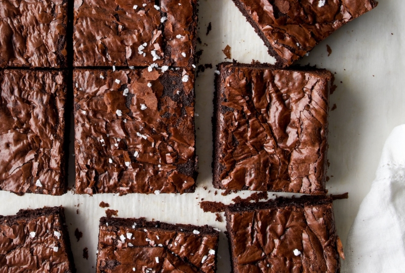 An overhead shop of brownies with sea salt flakes over the tops.