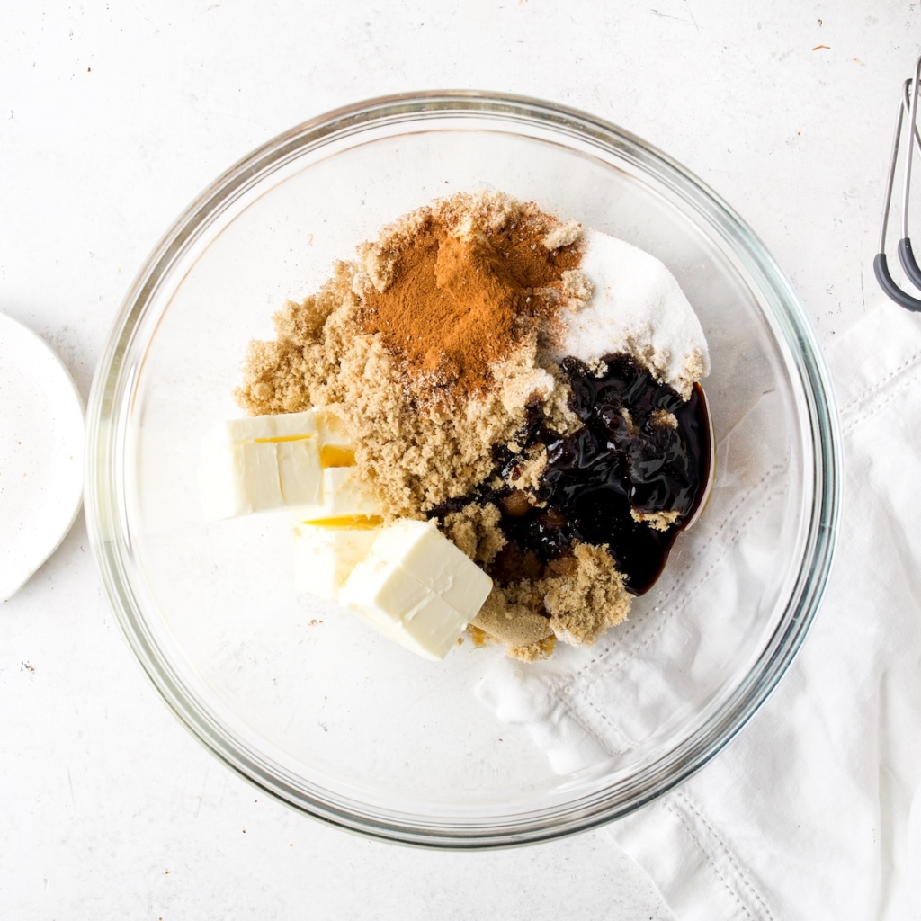 Butter, sugar, spices, molasses and vanilla in a glass bowl.
