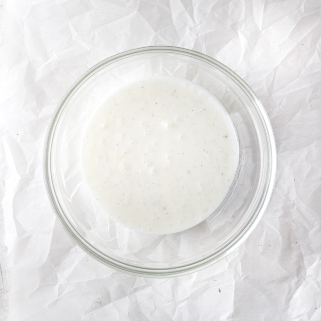 A bowl of thick, white vanilla glaze.