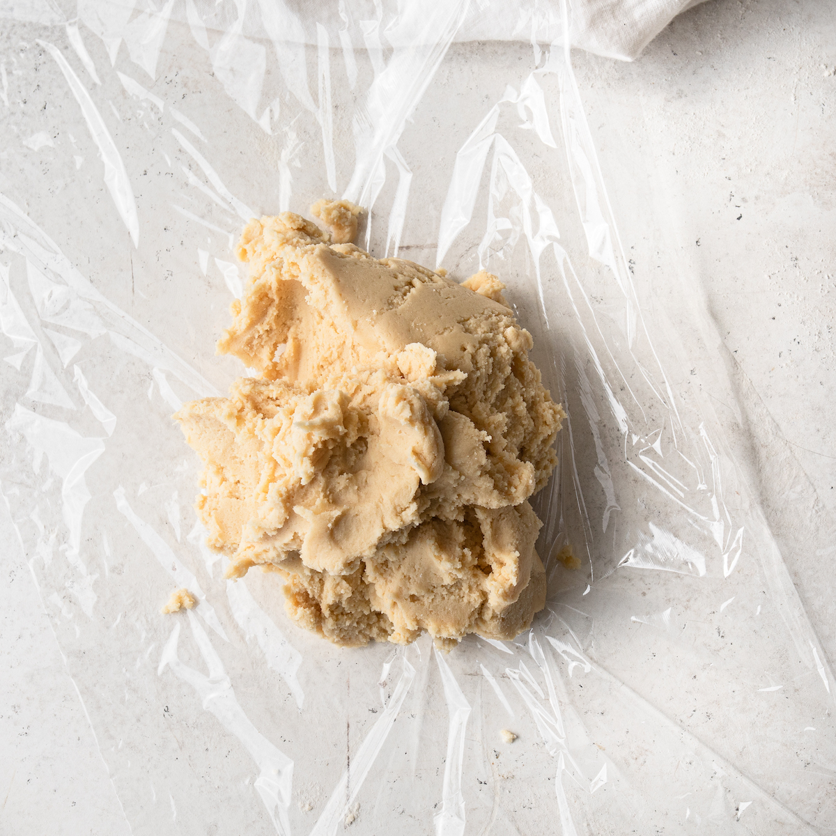 Cookie dough on top of plastic wrap.