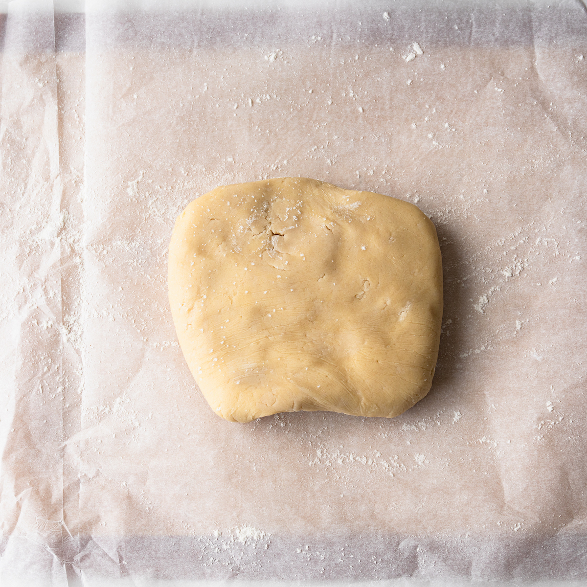 Cookie dough on top of parchment paper.