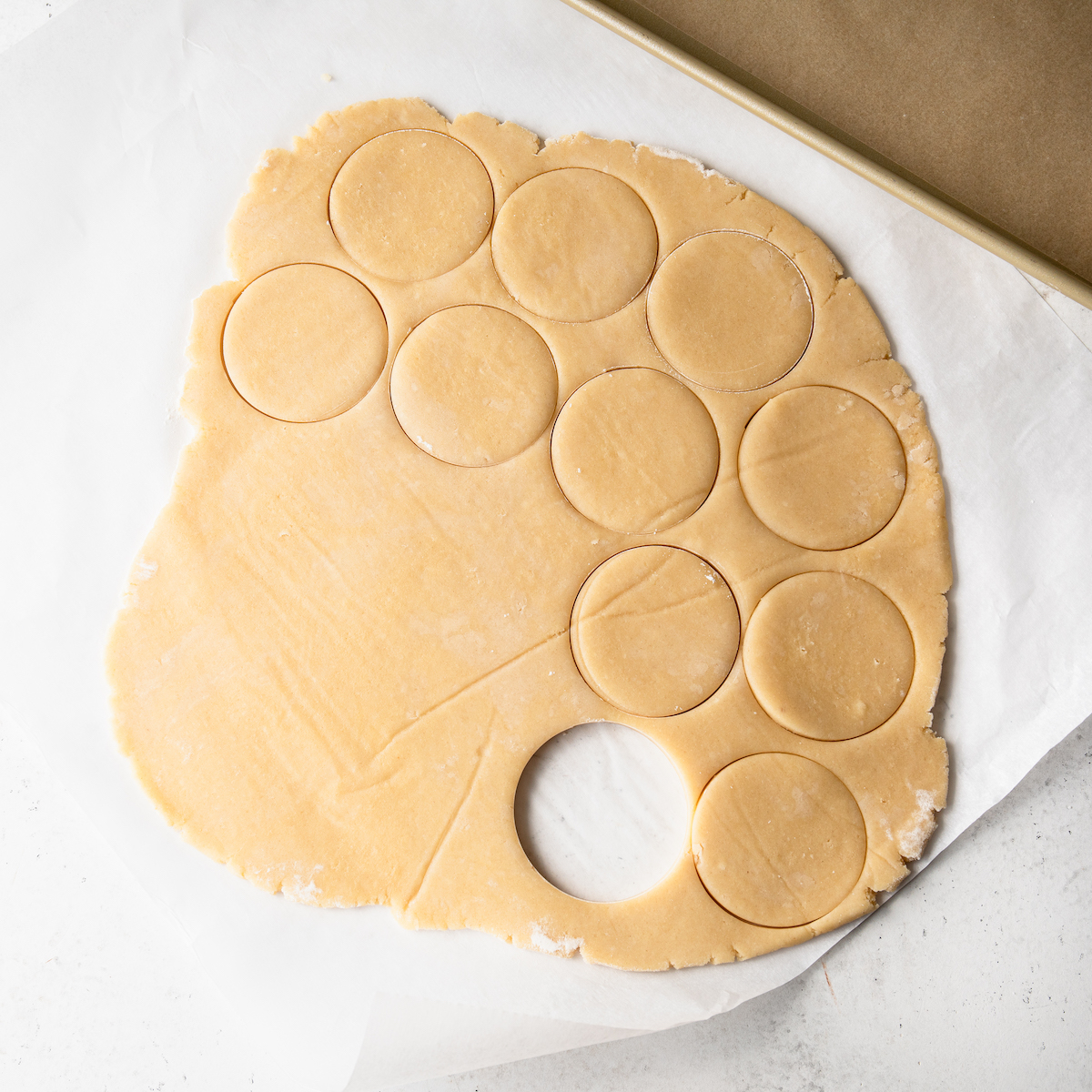 Lots of round cut outs of sugar cookie dough.